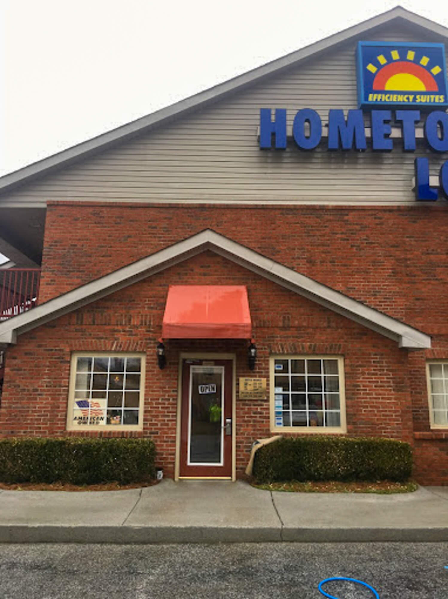 Commercial pressure washing service store front with canvas awning. Professional cleaning results.