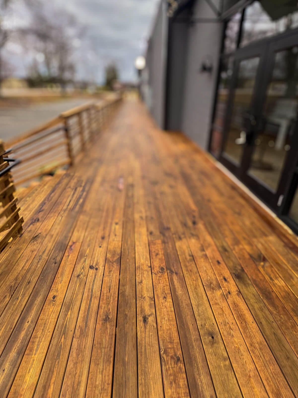 Professional commercial deck pressure washing, staining, and sealing service. High-quality commercial pressure cleaning for wood decks, ensuring long-lasting protection.