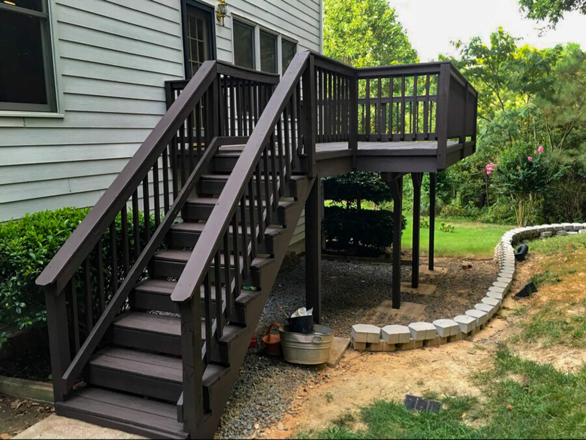 Freshly pressure-washed and hand-stained deck with a flawless finish, enhancing outdoor beauty and longevity. COST FOR DECK STAIN AND SEAL