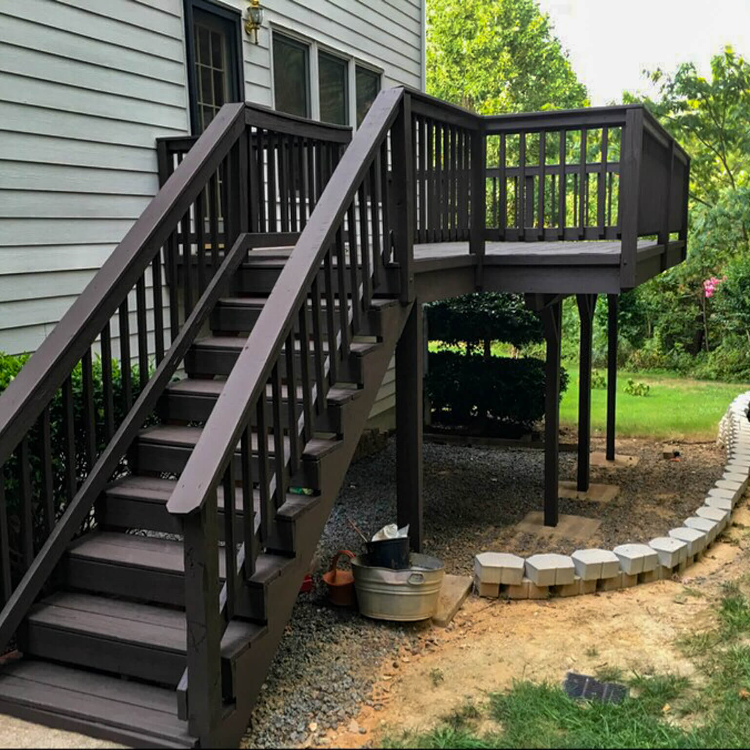 Freshly pressure-washed and hand-stained deck with a flawless finish, enhancing outdoor beauty and longevity.